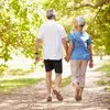 Older adults strolling under trees