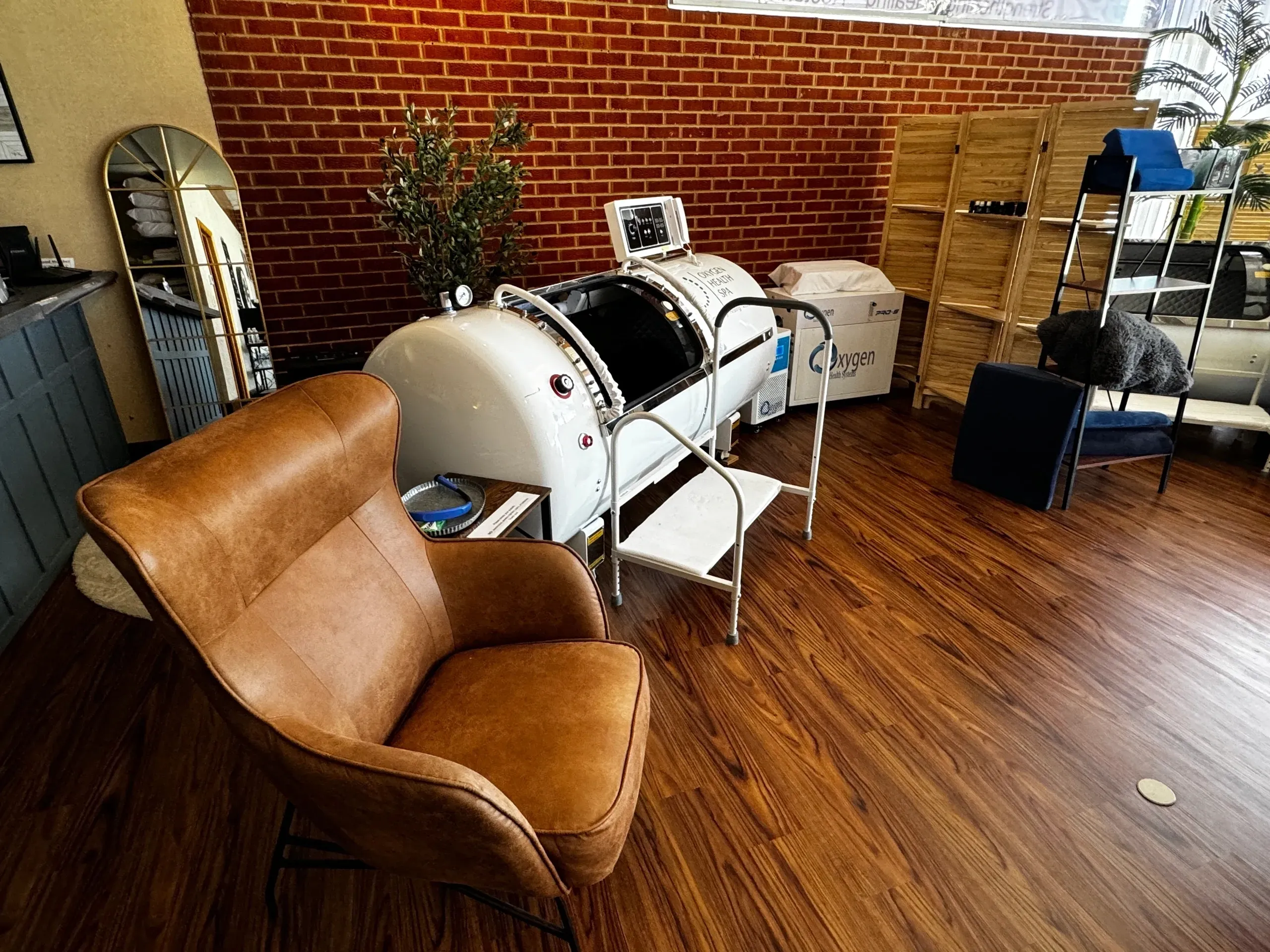 Brown chair and hyperbaric chamber in room